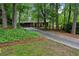Charming home nestled in a wooded lot featuring a long driveway and brick facade at 2700 Regency E Dr, Tucker, GA 30084