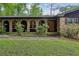 A charming brick home with arched windows and a well-manicured lawn at 2700 Regency E Dr, Tucker, GA 30084