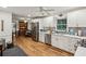 Updated kitchen features bright white cabinets, stainless steel appliances, and modern finishes at 2700 Regency E Dr, Tucker, GA 30084