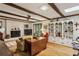 Inviting living room featuring wood floors, a brick fireplace and a custom built-in shelving unit at 2700 Regency E Dr, Tucker, GA 30084