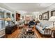 Bright living room with large windows, wood floors, vintage furnishings, and open layout at 2700 Regency E Dr, Tucker, GA 30084