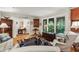 Cozy living area featuring hardwood floors, arched windows overlooking lush greenery, and vintage decor at 2700 Regency E Dr, Tucker, GA 30084