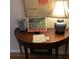 Decorated half-round table with lamp, Japan poster, and blue/white ceramic vases adding an artistic touch at 2700 Regency E Dr, Tucker, GA 30084