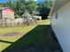 Backyard featuring green grass and a white brick home at 2875 Carriage Ln, Atlanta, GA 30349