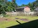Backyard featuring green grass, a fence, and shade from trees at 2875 Carriage Ln, Atlanta, GA 30349