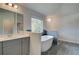Bathroom featuring a soaking tub set in dark tile, accented by a gray vanity at 68 Homesite Cooper W Cv, Fayetteville, GA 30214