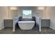 Bathroom featuring a modern soaking tub, framed by tile, and dual vanities at 68 Homesite Cooper W Cv, Fayetteville, GA 30214