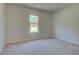 Cozy bedroom with neutral carpet and a large window offering natural light at 68 Homesite Cooper W Cv, Fayetteville, GA 30214