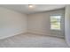 Light-filled bedroom boasts plush carpeting and large windows offering views of the surroundings at 68 Homesite Cooper W Cv, Fayetteville, GA 30214