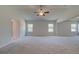 Expansive bedroom with plush carpet, tray ceiling, ceiling fan, and great natural light at 68 Homesite Cooper W Cv, Fayetteville, GA 30214