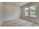 Bright, airy bedroom with large windows and light hardwood floors, offering a serene space at 68 Homesite Cooper W Cv, Fayetteville, GA 30214