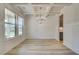 Formal dining room featuring modern lighting, wainscoting, and large windows for natural light at 68 Homesite Cooper W Cv, Fayetteville, GA 30214