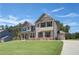 Inviting two-story home with a mix of brick and siding, complemented by a green lawn at 68 Homesite Cooper W Cv, Fayetteville, GA 30214
