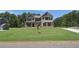 Beautiful two-story brick home with well-manicured lawn and a welcoming front entrance at 68 Homesite Cooper W Cv, Fayetteville, GA 30214
