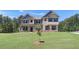 Charming two-story home with brick and siding, showcasing a well-kept lawn at 68 Homesite Cooper W Cv, Fayetteville, GA 30214
