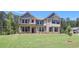 Attractive two-story home featuring a brick facade, siding accents, and a lush green lawn at 68 Homesite Cooper W Cv, Fayetteville, GA 30214