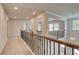 Second floor hallway features wood and iron railing at 68 Homesite Cooper W Cv, Fayetteville, GA 30214