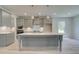 Spacious kitchen featuring a large center island, pendant lighting, and sleek gray cabinetry at 68 Homesite Cooper W Cv, Fayetteville, GA 30214