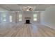 Bright, open living room with fireplace, and wood-look floors at 68 Homesite Cooper W Cv, Fayetteville, GA 30214
