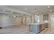 Open-concept living room with coffered ceiling and wood-look floors at 68 Homesite Cooper W Cv, Fayetteville, GA 30214