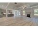 Bright open living room flows into a modern kitchen, offering hardwood floors, and a fireplace at 68 Homesite Cooper W Cv, Fayetteville, GA 30214