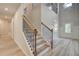 Elegant staircase with wood and wrought iron detailing leading to a bright, open upper level at 68 Homesite Cooper W Cv, Fayetteville, GA 30214