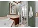 Bathroom featuring shower with white tiling and a cream vanity with dark wood cabinets at 1421 Peachtree Ne St # 214, Atlanta, GA 30309