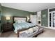 Spacious bedroom with large windows for natural light, light carpet, and green walls at 1421 Peachtree Ne St # 214, Atlanta, GA 30309
