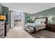 Spacious bedroom with large windows for natural light, light carpet, and green walls at 1421 Peachtree Ne St # 214, Atlanta, GA 30309