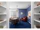 Elegant dining room with blue walls, built-in shelving, and a chandelier over a dining table at 1421 Peachtree Ne St # 214, Atlanta, GA 30309