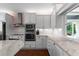 Bright kitchen featuring custom cabinets, stainless steel appliances, and a cozy eat-in breakfast area at 1421 Peachtree Ne St # 214, Atlanta, GA 30309