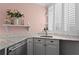Stylish kitchen with marble counters, stainless appliances, and a view of the backyard through shuttered windows at 1421 Peachtree Ne St # 214, Atlanta, GA 30309
