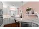 Kitchen featuring marble counters, stainless steel appliances, white cabinets, and a cozy breakfast bar at 1421 Peachtree Ne St # 214, Atlanta, GA 30309
