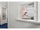 Charming kitchen view through a decorative window with white trim and a peek at the stylish interior at 1421 Peachtree Ne St # 214, Atlanta, GA 30309