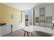Well-lit home office with built-in shelving, a large desk, and sliding doors to a balcony at 1421 Peachtree Ne St # 214, Atlanta, GA 30309