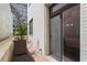 Private outdoor patio with brick wall, lounge chair, and sliding glass door access at 1421 Peachtree Ne St # 214, Atlanta, GA 30309