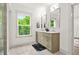 Bright bathroom with double vanity, ample natural light, and a view of the lush, green outdoors at 2318 Polar Rock Terrace, Atlanta, GA 30315