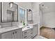 A bright bathroom with double sink vanity, attractive lighting, and a view into an adjacent room at 110 3Rd St, Fayetteville, GA 30214