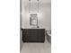 Bathroom featuring gray vanity, dark framed mirror, hanging pendant lights, and tiled flooring at 110 3Rd St, Fayetteville, GA 30214