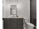 Bathroom featuring gray vanity, dark framed mirror, hanging pendant lights, and tiled flooring at 110 3Rd St, Fayetteville, GA 30214