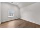 An empty bedroom with hardwood floors, natural light, and a vaulted ceiling at 110 3Rd St, Fayetteville, GA 30214