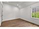 This bedroom features wood flooring, white walls, recessed lighting, and a bright window at 110 3Rd St, Fayetteville, GA 30214
