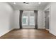 Bedroom featuring hardwood floors, recessed lighting, curtains over two windows, and a doorway at 110 3Rd St, Fayetteville, GA 30214