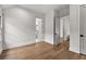 A light-filled bedroom showcasing hardwood floors and multiple doorways to additional spaces at 110 3Rd St, Fayetteville, GA 30214