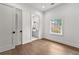 Bedroom with hardwood floors and a large window overlooking the yard at 110 3Rd St, Fayetteville, GA 30214