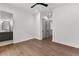 Bright bedroom with hardwood floors, ceiling fan, and view of ensuite bath through an open doorway at 110 3Rd St, Fayetteville, GA 30214