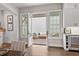 Dining room leading to brick patio with double doors, table set for dining, and white cabinets at 110 3Rd St, Fayetteville, GA 30214