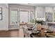 Dining room leading to brick patio with double doors, table set for dining, and white cabinets at 110 3Rd St, Fayetteville, GA 30214