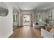 Elegant foyer with hardwood flooring, a modern white sofa, and a view of the front entrance through double doors at 110 3Rd St, Fayetteville, GA 30214
