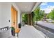 Charming front porch featuring a wooden door, comfortable seating, and decorative greenery for a welcoming curb appeal at 110 3Rd St, Fayetteville, GA 30214